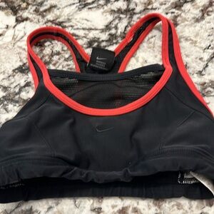 Nike sports bra, black with dark orange trim. Netting in back as shown in photo.